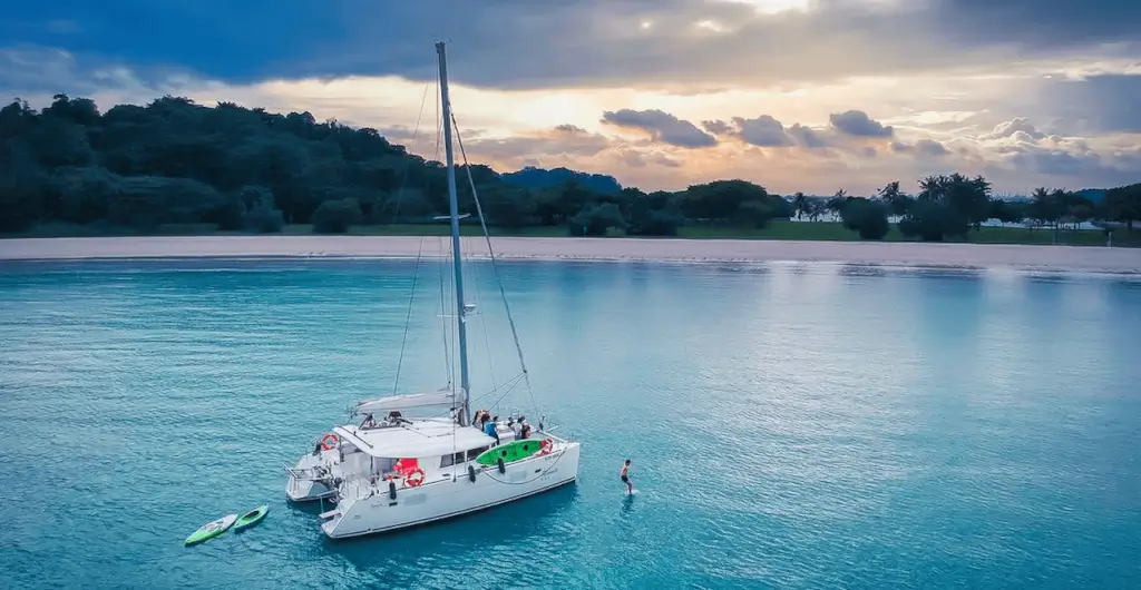 Ximula Lagoon 400 S2 sailing catamaran aerial view from above, Marina Bay backdrop